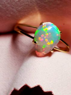 14k solid gold opal ring, beautiful opal with many bright rainbows adorning it mounted on a gold split shank ring. The ring is light and easy to wear and comes in 6 sizes I can swap the stone into. 14k Yellow Gold Opal Promise Ring, Ethiopian Opal Fine Jewelry Ring, Yellow Gold Opal Ring In Fine Jewelry Style, Fine Jewelry Yellow Gold Opal Ring, Yellow Gold Opal Birthstone Ring, Ethiopian Opal Promise Ring, Fine Jewelry 14k Gold Pear-shaped Opal Ring, 14k Gold Pear-shaped Opal Ring Fine Jewelry, 14k Gold Pear-shaped Opal Ring