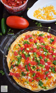 a pizza sitting on top of a pan covered in cheese and veggie toppings