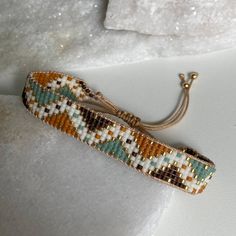 a beaded bracelet sitting on top of a white surface