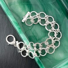 Handmade chain bracelet of heavy round links that are double connected. Sterling silver bracelet closes with a lobster clasp. These link chain bracelets fall gracefully around the wrist and hand in sterling silver. Link bracelets also make a great gift for a friend or family member. Size: Length is 7 1/2" and Width is 1". Weight 37.7 grams or 1.33 oz Bracelet Sizing: A good guide for your correct bracelet length is 1/2" longer than a tight wrist measurement. Use a flexible tape measure or strip of paper, then measure the paper strip with ruler. Composition: Handmade and one of a kind in nickel free sterling silver. Processing Time: Usually I can ship the item out within 2 days from the order date unless there is a back order. Back orders will be shipped within 2 weeks of the order date. SH Sterling Silver Chain Bracelet For Jewelry Making, Modern Sterling Silver Bracelets With Rolo Chain, Silver Sterling Silver Chain Link Charm Bracelet, Silver Link Bracelets With Rolo Chain, Modern Silver Rolo Chain Bracelet, Sterling Silver Jubilee Charm Bracelet, Nickel-free Sterling Silver Chain Link Bracelet, Silver Charm Bracelet With Rolo Chain Links, Sterling Silver Clasp Chain Bracelet