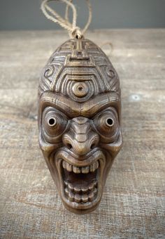 Kalu, the Soulless Magic Man. A single (1) limited edition individual beautifully handcrafted miniature tiki mask  ornament in natural wood color. A perfect unique gift for yourself or the the Tiki lover, Adventurer,  Gothic, Fantasy or Horror fan.  Each Tiki Mask is made of 3D resin printed at 4K resolution. Hand painted details and stands at 4.5 inches tall. Ready to give as a gift,  or hang the tree for the Holidays.  Handmade in USA Tiki Maske, Tiki Mask, Magic Man, Art Object, Natural Color, Sculpture Art, Unique Gifts, Miniatures, Gift Card