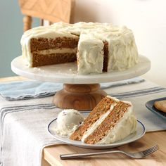 a slice of carrot cake on a plate next to the rest of the cake and ice cream