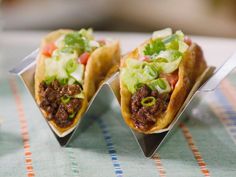 three tacos sitting on top of a table