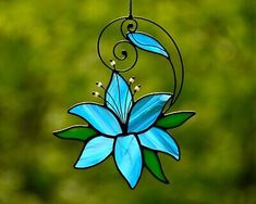 a stained glass flower hanging from a wire