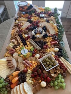 a long table covered with lots of different types of food and cheeses on top of it