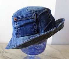 a denim hat is sitting on top of a mannequin