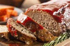 sliced meatloaf with ketchup on a cutting board