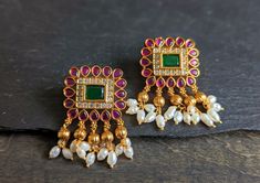 Adorn your ears with these classic squared shape ruby stud earrings with cz and emerald stones in matter gold finish Width: 1 Inches Length: 1.5 Inches Big Studs Earrings Indian, Indian Stud Earrings, Gold Buttalu, Big Stud Earrings, Ruby Stud Earrings, Ruby Earrings Studs, Gold Earrings Models, Emerald Earrings Studs, Designer Outfits