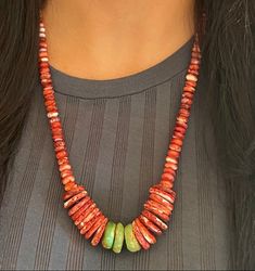 The bright coral colored carved natural beads of this necklace are made of spiny oyster shell. The smaller beads are all polished and the same size, running along the length of the necklace with hues of red and cream. The larger discs closer to the center still have some remnant of texture from the Native Necklace, Spiny Oyster Turquoise, Oyster Turquoise, Beaded Bib Necklace, Vintage Silver Jewelry, Native Jewelry, Southwestern Jewelry, Spiny Oyster, Oyster Shell