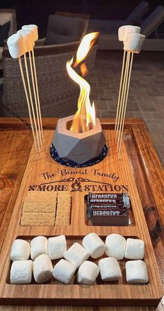 marshmallows and marshmallow sticks on a wooden tray