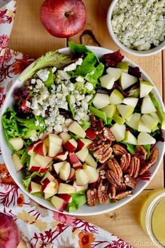 a salad with apples, pecans and cheese