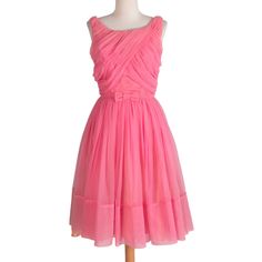 Adorable ruffly pink dress from the 60s with sheer layer overtop of dress that ruffles at bust and layers at sweep. Includes a dainty bow on front waist and zipper in back. Poly chiffon layer over a taffeta underskirt.  Measurements Bust: 34" Waist: 28" Length: 41" Sweep: ~108" Condition: Great; some light stains and color fading (See images) still present well! Gently priced due to flaws. Pink Retro Silk Dress, Pink Silk Retro Dress, Pink Sleeveless 1950s Dress, 1960s Pink Dress, Pink Vintage Dress With Button Closure, Pink Party Dress, 1960s Dresses, Pink Party Dresses, Pink Party