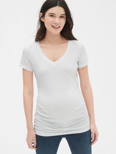 Supersoft knit with a smooth finish.  Short sleeves.  V-neck.  Ruching along sides for more belly room.  Please note: Maternity styles cannot be returned in store.  Please enjoy free returns by mail. Gap Stretch Seamless Tops, V-neck Stretch T-shirt For Layering, Stretch V-neck T-shirt For Layering, Gap Short Sleeve Stretch Top, Gap Stretch Short Sleeve Tops, Fitted White Gap Top, White Fitted Top By Gap, Maternity Styles, Gap Maternity