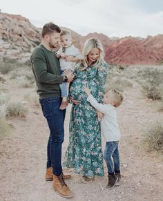 a man, woman and child are standing in the desert with their arms around each other