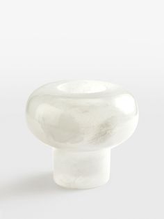 a white glass knob on a white background