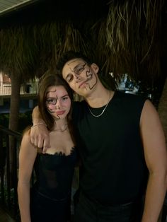 two people with painted faces posing for a photo