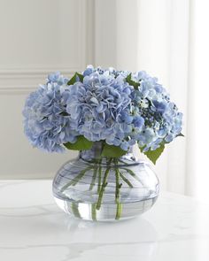 a vase filled with blue flowers on top of a table