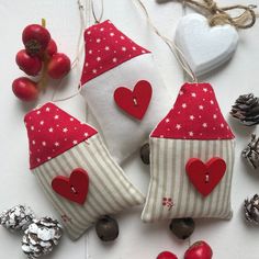 three red and white christmas decorations with hearts on them