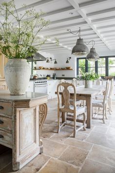 a large kitchen with an island and dining room table