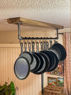 pots and pans are hanging from the ceiling