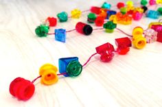 a string of colorful beads on a white surface