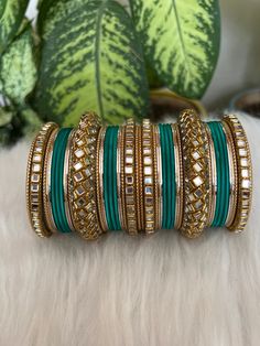 The perfect accessory for your special occasions, these Rama  green   and Golden Color Bangles feature Kundan and Stone detailing. Crafted with copper, these bangles are sure to add a touch of elegance and glamour to your look. Features: * Copper material *  kundan  detailing *  Rama  green  and Golden Color * Size: 2.6,2.8,2.10 Elegant Turquoise Bangle For Wedding, Festive Green Bangle As Gift, Festive Green Bangle For Gift, Adjustable Green Bracelets For Festivals, Traditional Green Bracelets For Festivals, Adjustable Green Bangle For Wedding, Handmade Green Bracelets For Festive Season, Festive Green Handmade Bracelets, Adjustable Green Wedding Bangle