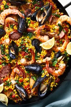 a skillet filled with seafood and rice