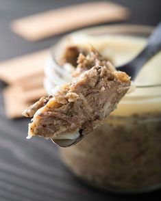 a spoon full of peanut butter and oatmeal on top of a jar