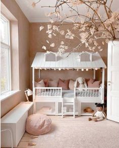 a white bunk bed sitting next to a window in a room with pink walls and furniture