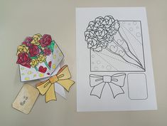 a card with flowers on it next to an envelope