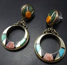 VINTAGE CHANNEL INLAY EARRINGS DESCRIPTION:  Featuring perfect channel inlay of green and blue turquoise, orange and red spiny oyster shell, black jet, and mother of pearl set in heavy gauge sterling silver, these earrings will be a cherished addition to your collection of quality vintage Southwestern and Native American jewelry.. MEASUREMENTS:  Earrings measures 2" x 1" WEIGHT: 19.4 grams SIGNED: no STERLING:  yes, stamped STERLING Vintage Channel, Jewelry Measurements, Black Jet, Cowgirl Jewelry, Spiny Oyster, Pearl Set, Oyster Shell, American Jewelry, Multi Stone