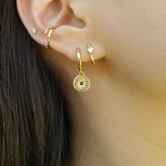 "Delicate rising sun disc huggie hoops offer bright golden shine to your everyday look. ♥ Created 18K gold plated on the top of 925 sterling silver ♥ Measurement of rising sun charm: 9 mm diameter excl. connector ♥ Diameter of hoops: outer - 12.5 mm / inner - 9.5 mm ♥ Sold as single or a pair ♥ Nickel free ♥ All items are packed inside an elegant Gold Spoon jewelry box. If you are purchasing a product to send as a gift, we can send the product directly to the recipient. Please ensure you write t Everyday Celestial Huggie Earrings, Celestial Huggie Pierced Earrings, Celestial Small Hoop Huggie Earrings, Celestial Gold Huggie Earrings, Gold Celestial Dangle Huggie Earrings, Gold Spoon, Sun Earrings, Celestial Earrings, Dainty Hoop Earrings