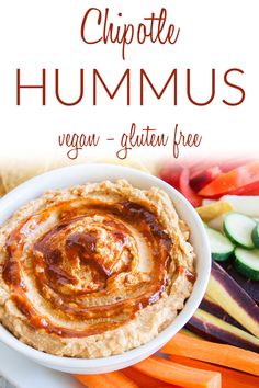 hummus in a bowl with carrots, celery and cucumbers