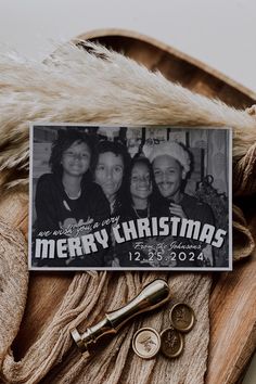 a christmas card sitting on top of a fur coat next to two keys and a pair of scissors