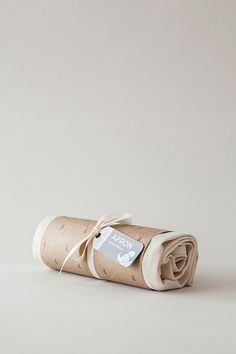 a rolled up roll of toilet paper with a tag on it