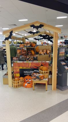 an open market with pumpkins and other items on display in the store's aisles