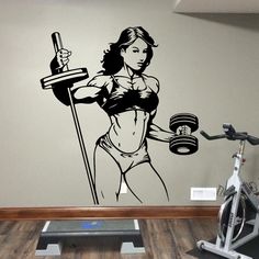 a wall decal with a woman holding a barbell