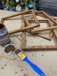 a paintbrush sitting next to some unfinished wood pieces