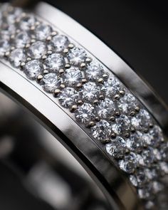 a close up view of a wedding ring with diamonds on the outside and inside it