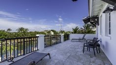 a balcony with two chairs and a table on it