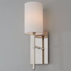 a wall light with a white shade on it's side and a gray background