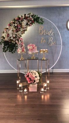 a table with candles and flowers on it in front of a sign that says bridal to be