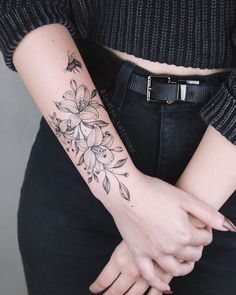 a woman with a flower tattoo on her arm