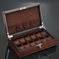 an open wooden watch box on a table