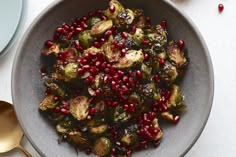 a bowl filled with brussel sprouts and pomegranate