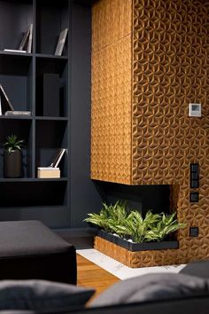 a living room filled with furniture and bookshelves next to a planter on the floor