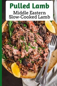 pulled lamb in a bowl with lemon wedges and parsley on the side for garnish