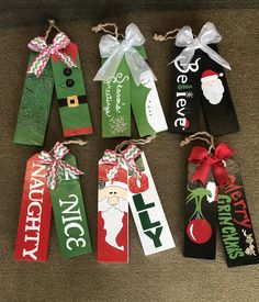 six christmas gift tags tied together with twine and ribbon on carpeted flooring