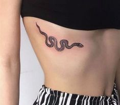 a woman with a snake tattoo on her stomach