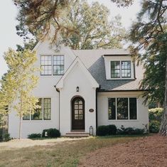 a white house with trees in the background